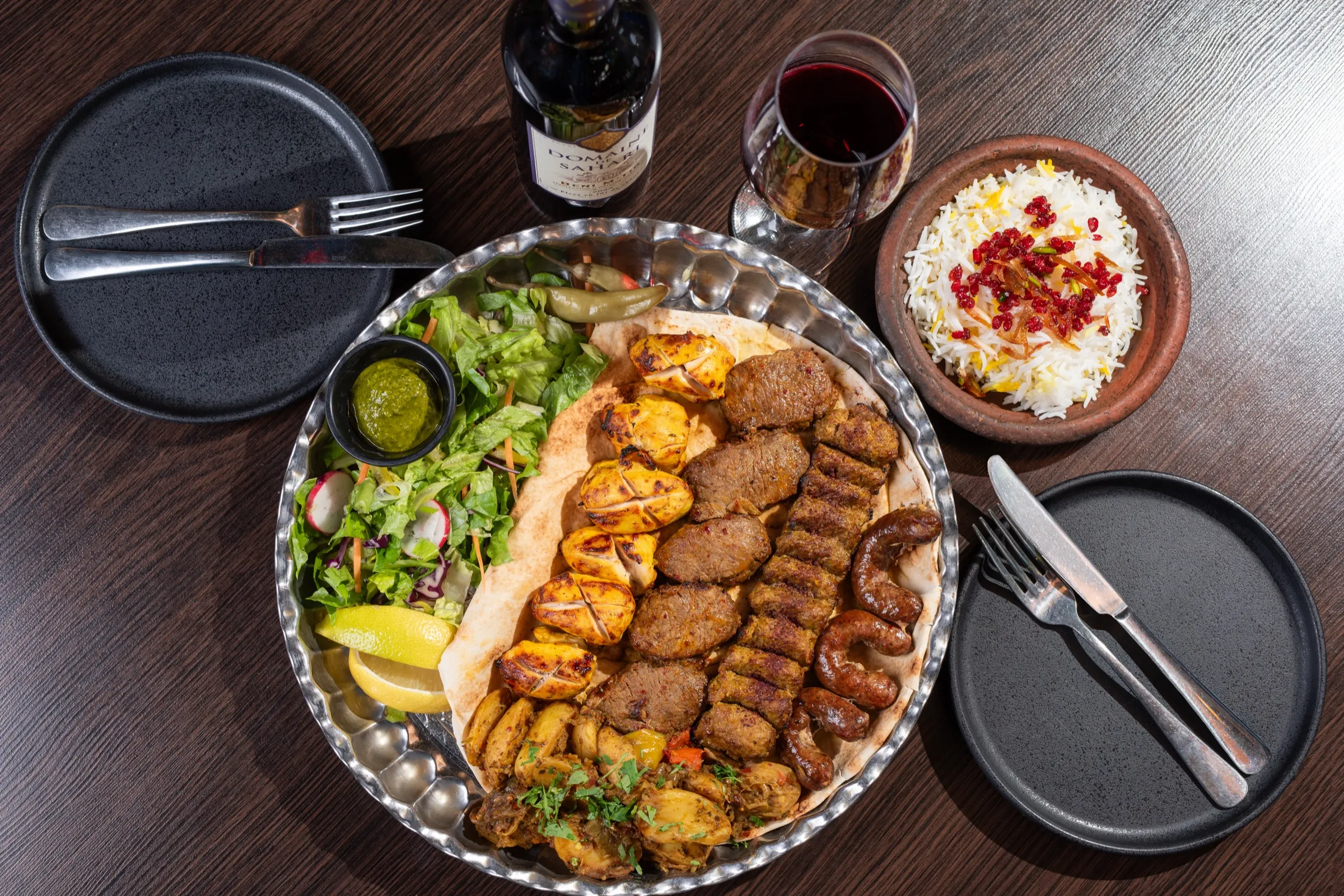 A large mixed-grill platter served with rice and salad